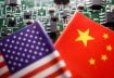 Flags of China and U.S. are displayed on a printed circuit board with semiconductor chips, in this illustration picture taken February 17, 2023. REUTERS/Florence Lo/Illustration