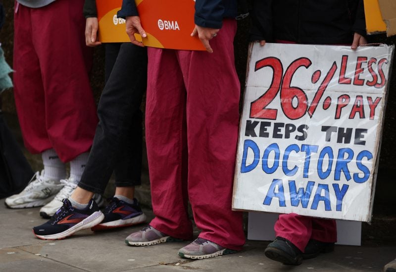 People attend a protest by junior doctors, amid a dispute with the government over pay, outside St Thomas' Hospital in London, Britain, March 13, 2023. REUTERS/Hannah McKay