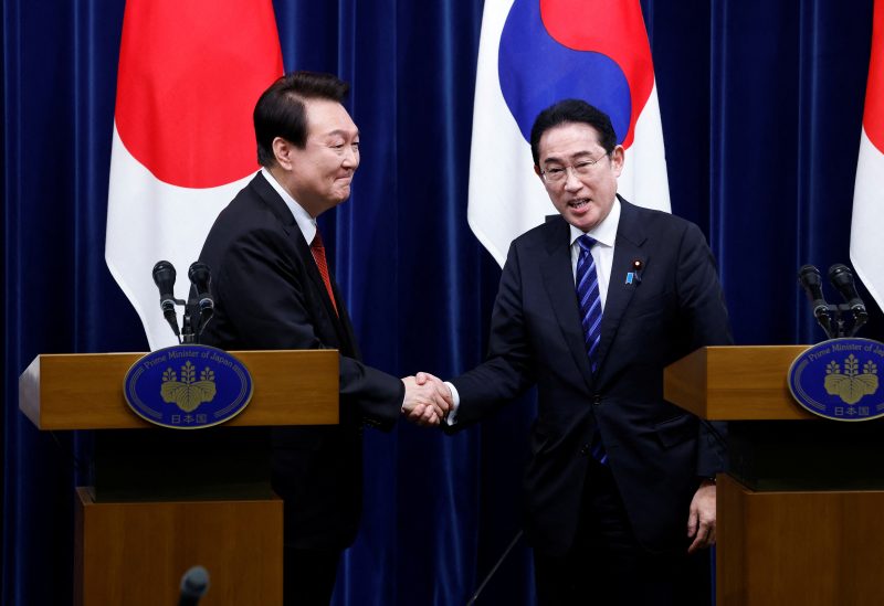 South Korea's President Yoon Suk Yeol and Japan's Prime Minister Fumio Kishida shake hands at a joint news conference at the prime minister's official residence in Tokyo, Japan March 16, 2023. Kiyoshi Ota/Pool via REUTERS