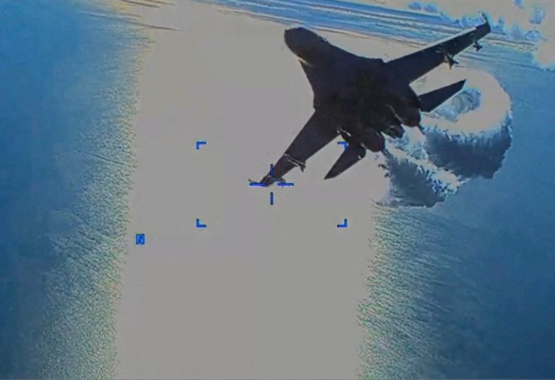 A Russian Su-27 military aircraft dumps fuel while flying by a U.S. Air Force MQ-9 "Reaper" drone over the Black Sea, March 14, 2023 in this still image taken from handout video released by the Pentagon. Courtesy of U.S. European Command/The Pentagon/Handout via REUTERS