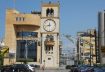 A woman walks near a clock tower that indicates the time in Jdeideh, Lebanon March 26, 2023. REUTERS/Mohamed Azakir