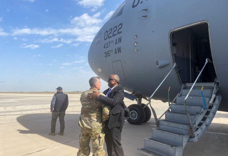 U.S. Defense Secretary Lloyd Austin embraces Major General Matthew McFarlane, during his unannounced trip to Baghdad, Iraq, March 7, 2023. REUTERS