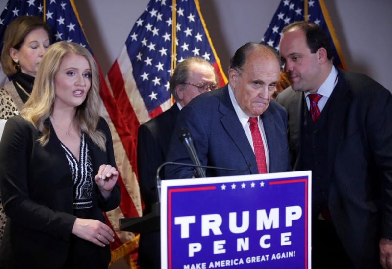 Trump Campaign Senior Legal Advisor Jenna Ellis speaks as Trump campaign advisor Boris Epshteyn whispers to former New York City Mayor Rudy Giuliani, personal attorney to U.S. President Donald Trump, during a news conference about the 2020 U.S. presidential election results at Republican National Committee headquarters in Washington, U.S., November 19, 2020. REUTERS