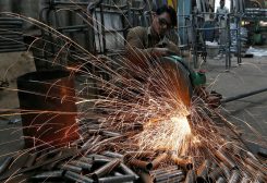 FILE PHOTO: A worker cuts a metal pipe inside a steel furniture production factory in the western Indian city of Ahmedabad February 2, 2015. REUTERS/Amit Dave (INDIA - Tags: BUSINESS INDUSTRIAL TPX IMAGES OF THE DAY)/File Photo