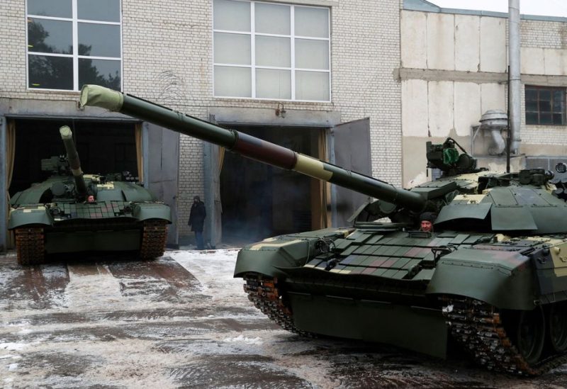 Employees drive modernized T-72 battle tanks at the Kyiv Armoured Plant before the ceremony of handing over to the servicemen of Ukrainian armed forces in Kyiv, Ukraine February 24, 2021. REUTERS