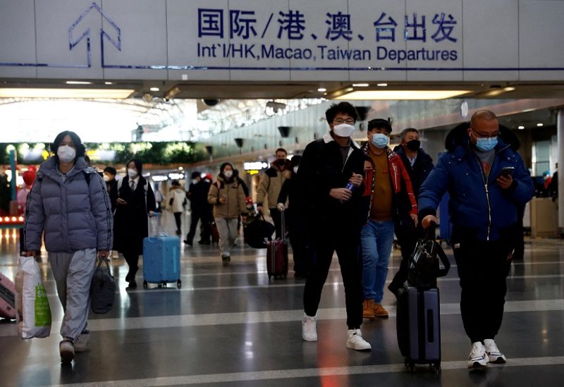 FILE PHOTO: Travellers walk with their luggage at Beijing Capital International Airport, amid the coronavirus disease (COVID-19) outbreak in Beijing, China December 27, 2022. REUTERS/Tingshu Wang/File Photo
