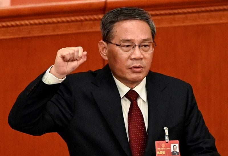 China's newly-elected Premier Li Qiang takes an oath after being elected during the fourth plenary session of the National People's Congress (NPC) at the Great Hall of the People in Beijing, China on March 11, 2023. GREG BAKER/Pool via REUTERS