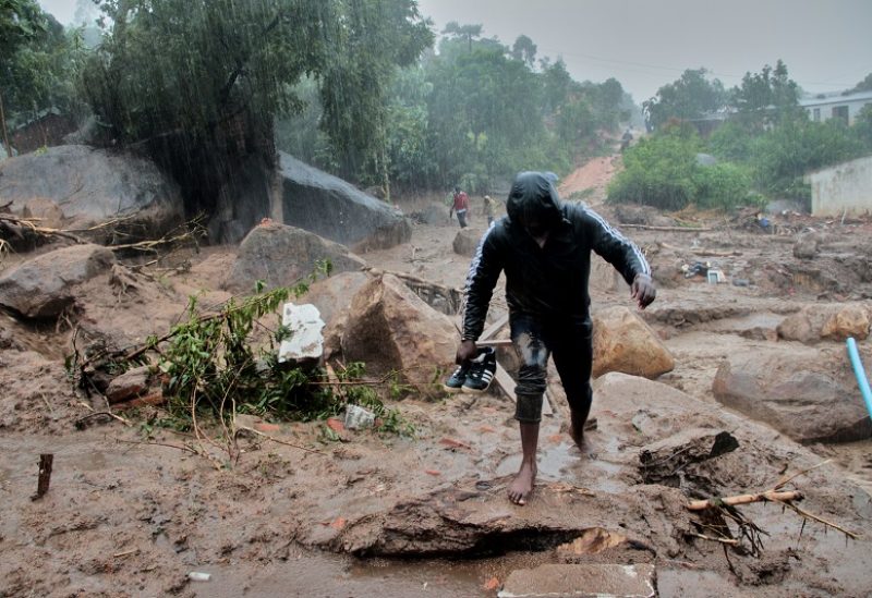 A man walks away from buildings damaged by Cyclone Freddy in Chilobwe, Blantyre, Malawi, March 13, 2023. REUTERS/Eldson Chagara.