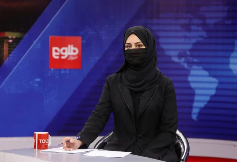 A female presenter for Tolo News, Khatereh Ahmadi, while covering her face, works in a newsroom at Tolo TV station in Kabul, Afghanistan, May 22, 2022. REUTERS