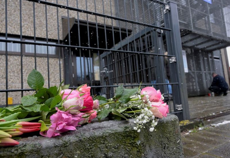 Floral tributes are laid outside a building housing a Kingdom Hall of Jehovah's Witnesses, where a deadly shooting took place, in Hamburg, northern Germany, March 10, 2023. REUTERS