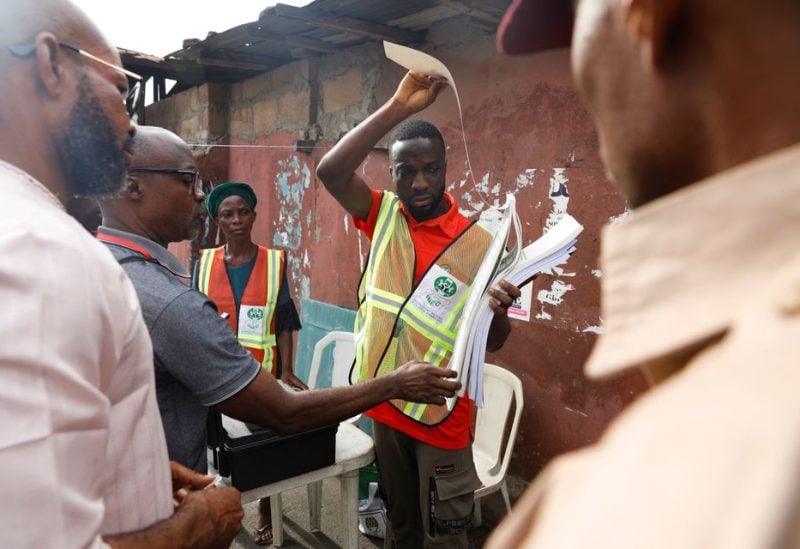 Party agents inspect electoral materials at a polling unit, during the gubernatorial election in Lagos, Nigeria March 18, 2023. REUTERS