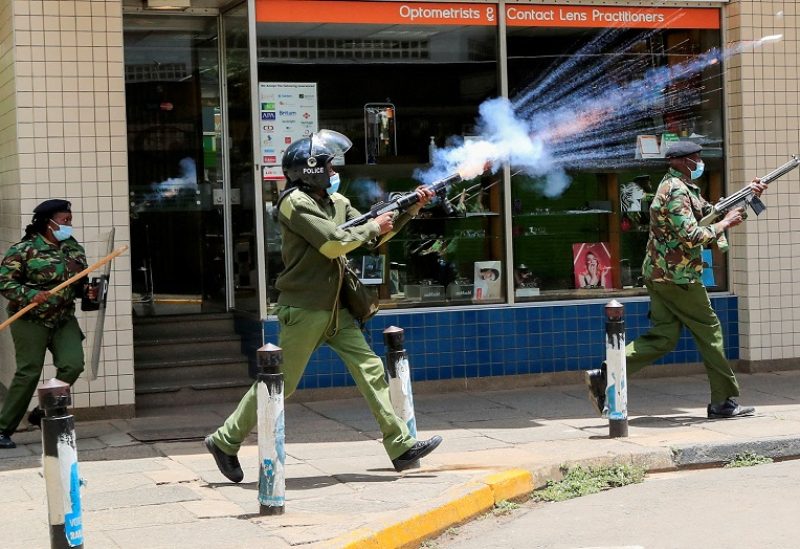 FILE PHOTO: A riot police officer fires tear gas to disperse supporters of Kenya's opposition leader Raila Odinga of the Azimio La Umoja (Declaration of Unity) One Kenya Alliance, as they participate in a nationwide protest over the cost of living and President William Ruto's government in downtown Nairobi, Kenya March 20, 2023. REUTERS/Thomas Mukoya/File Photo