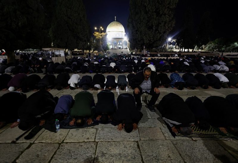 Palestinian worshippers perform the Taraweeh prayers by Al-Aqsa Mosque, with the Dome of the Rock seen in the background, on the compound known to Muslims as the Noble Sanctuary and to Jews as the Temple Mount, at the beginning of the holy fasting month of Ramadan in Jerusalem's Old City March 22, 2023. REUTERS/Ammar Awad