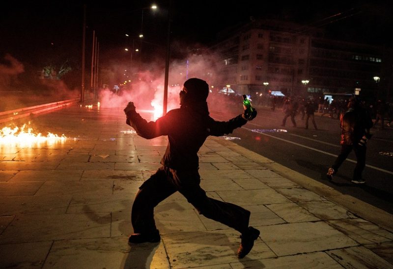 A protester prepares to throw a petrol bomb during a demonstration in front of the parliament building following the collision of two trains, near the city of Larissa, in Athens, Greece, March 3, 2023. REUTERS/Alkis Konstantinidis TPX IMAGES OF THE DAY