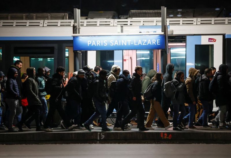 Suburban passengers disembark a train at the Saint-Lazare train station during a nationwide day of strike and protests against the French government's pension reform plan, with heavy disruption on French SNCF railway and the Paris transport RATP networks, in Paris, France, March 7, 2023 - REUTERS