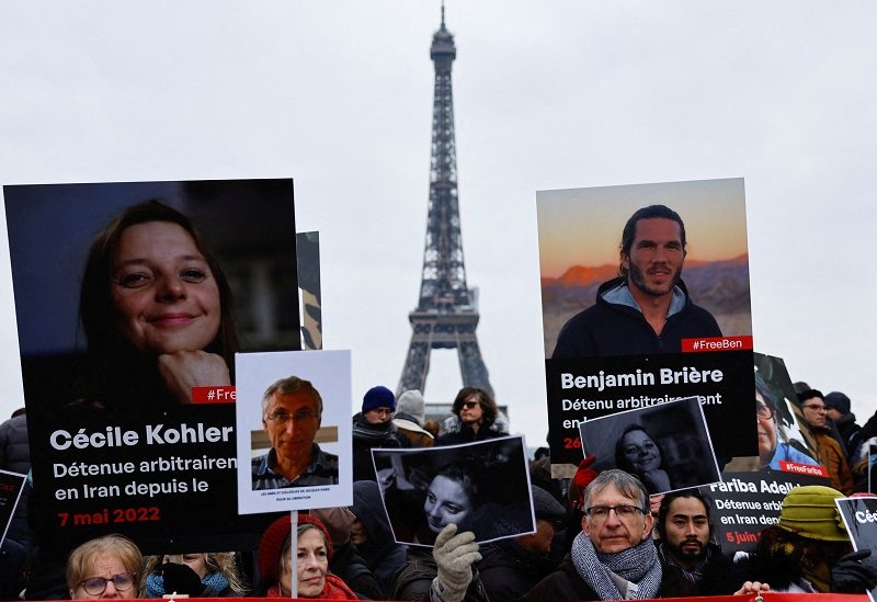 FILE PHOTO: Supporters and relatives of French citizens detained in Iran, Cecile Kohler, Benjamin Briere, Jacques Paris and Fariba Adelkhah, gather in front of the Eiffel Tower, during a rally demanding their release, in Paris, France, January 28, 2023. REUTERS/Christian Hartmann/File Photo