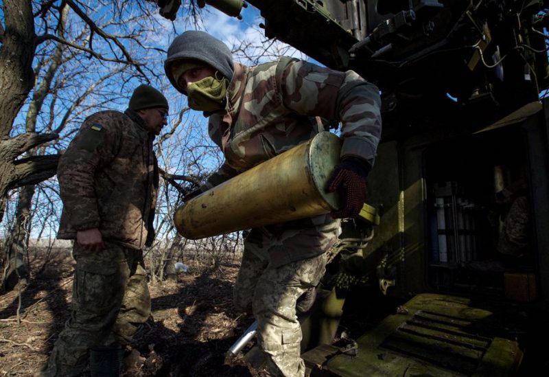 A Ukrainian serviceman carries a shell for a 2S5 Giatsint-S self-propelled howitzer before firing towards Russian troops outside the frontline town of Bakhmut, amid Russia's attack on Ukraine, in Donetsk region, Ukraine March 5, 2023 - REUTERS