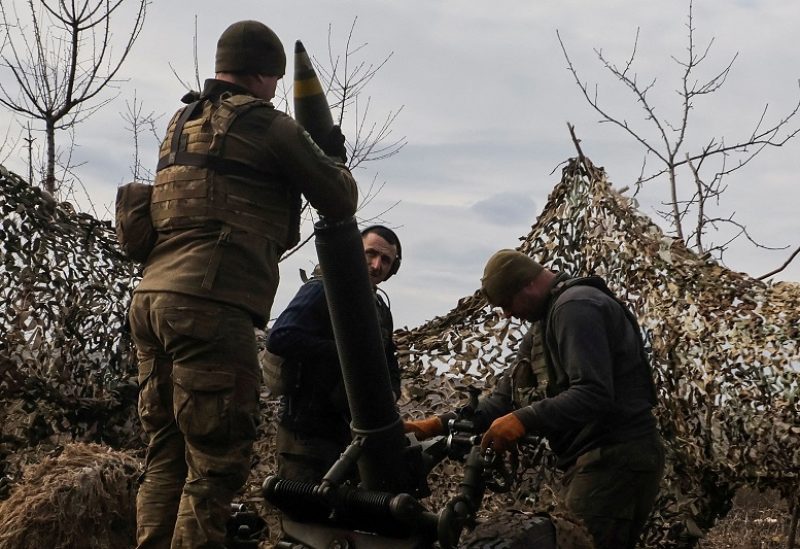 FILE PHOTO: Ukrainian service members load a shell to a mortar before firing towards Russian troops outside the frontline town of Bakhmut, amid Russia's attack on Ukraine, in Donetsk region, Ukraine March 6, 2023. Radio Free Europe/Radio Liberty/Serhii Nuzhnenko via REUTERS THIS IMAGE HAS BEEN SUPPLIED BY A THIRD PARTY./File Photo