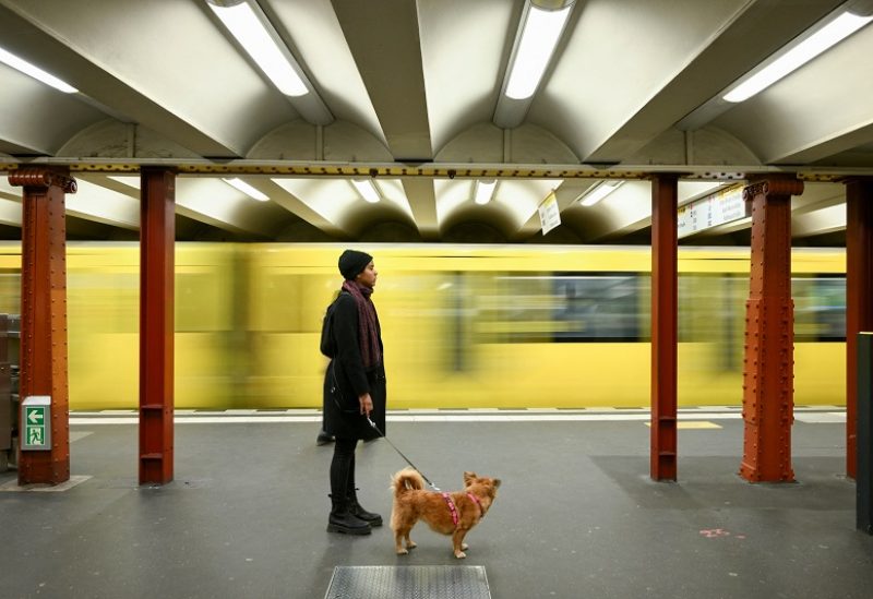 A commuter with a dog stands on a Berlin transport company BVG subway platform at Alexanderplatz station during a nationwide strike called by the German trade union Verdi over a wage dispute, in Berlin, Germany, March 27, 2023. REUTERS/Annegret Hilse