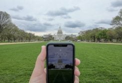 A mobile phone showing the time at noon, is displayed for a photo in front of the United States Capitol, which is completely empty, during the coronavirus disease (COVID-19) outbreak, in Washington, U.S., March 31, 2020. REUTERS/Jonathan Ernst