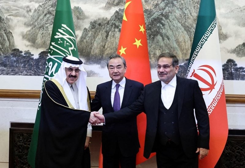 FILE PHOTO: Wang Yi, a member of the Political Bureau of the Communist Party of China (CPC) Central Committee and director of the Office of the Central Foreign Affairs Commission, Ali Shamkhani, the secretary of Iran’s Supreme National Security Council, and Minister of State and national security adviser of Saudi Arabia Musaad bin Mohammed Al Aiban pose for pictures during a meeting in Beijing, China March 10, 2023. China Daily via REUTERS ATTENTION EDITORS - THIS IMAGE WAS PROVIDED BY A THIRD PARTY. CHINA OUT./File Photo