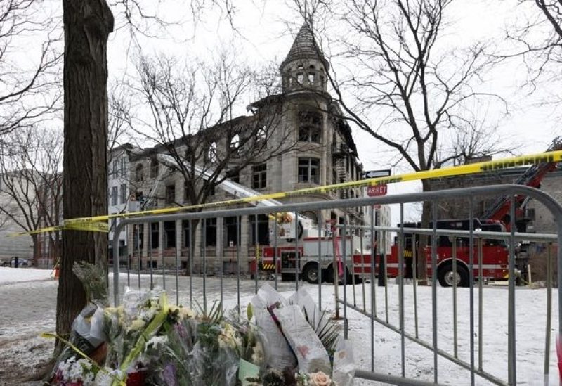 A firefighter and police investigators inspect a three-storey heritage building in Old Montreal where a fire broke out last week leaving seven people unaccounted for, in Montreal, Quebec, Canada March 19, 2023. REUTERS/Christinne Muschi