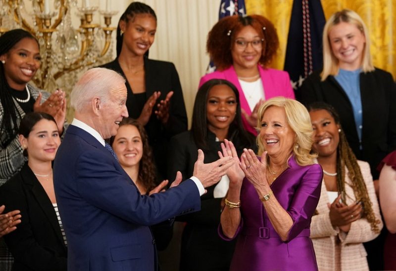 U.S. President Joe Biden and first lady Jill Biden react while hosting a reception celebrating Women's History Month at the White House in Washington, U.S., March 22, 2023. REUTERS/Kevin Lamarque