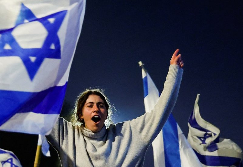 People attend a demonstration after Israeli Prime Minister Benjamin Netanyahu dismissed the defense minister and his nationalist coalition government presses on with its judicial overhaul, in Jerusalem, March 27, 2023. REUTERS/Ammar Awad