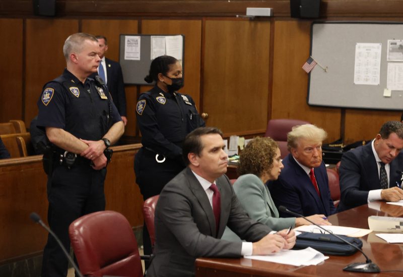 Former U.S. President Donald Trump appears in court with members of his legal team for an arraignment on charges stemming from his indictment by a Manhattan grand jury following a probe into hush money paid to porn star Stormy Daniels, in New York City, U.S., April 4, 2023. REUTERS/Andrew Kelly/Pool