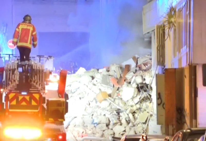 A firefighter stands on a fire truck after a building collapsed in Marseille, France, April 9, 2023, in this screengrab obtained from a social media video. BFMTV/via REUTERS