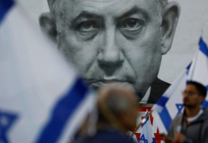 Protesters hold Israeli flags during a demonstration against Israeli Prime Minister Benjamin Netanyahu and his nationalist coalition government's judicial overhaul, in Tel Aviv, Israel April 15, 2023. REUTERS/Nir Elias