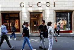 People walk outside a Gucci shop in Rome, April 20, 2023. REUTERS/Remo Casilli