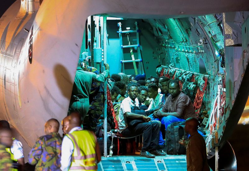 Evacuees from war-torn Sudan sit inside a military plane as they wait to be processed by members of the Kenya Defence Forces (KDF) upon their arrival at the Jomo Kenyatta International Airport in Nairobi, Kenya, April 24, 2023. REUTERS/Thomas Mukoya