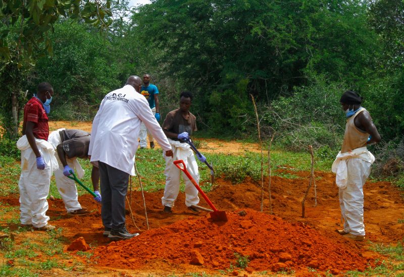 Volunteers assist forensic experts and homicide detectives from the Directorate of Criminal Investigations (DCI), to exhume bodies of suspected followers of a Christian cult named as Good News International Church, whose members believed they would go to heaven if they starved themselves to death, in Shakahola forest of Kilifi county, Kenya April 25, 2023. REUTERS/Joseph Okanga