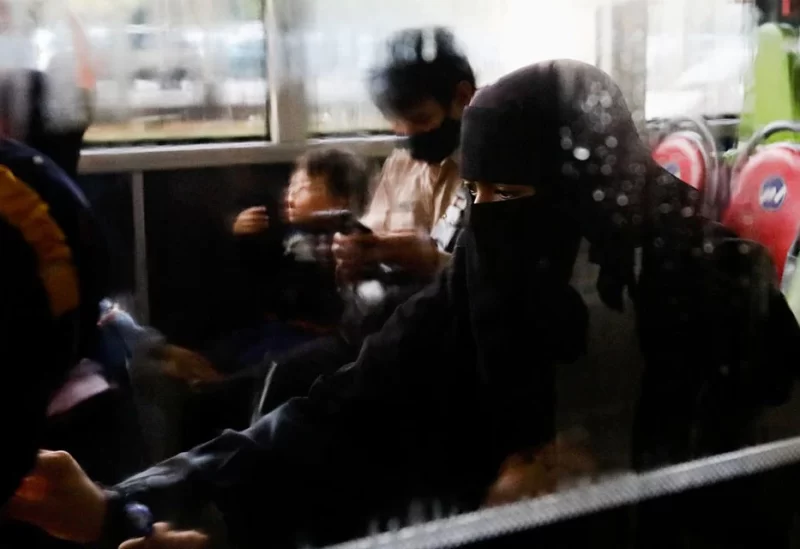 An Indonesian citizen evacuated from Sudan sits in a bus after she arrives at the Soekarno-Hatta Airport in Tangerang, on the outskirts of Jakarta, Indonesia, April 28, 2023. REUTERS