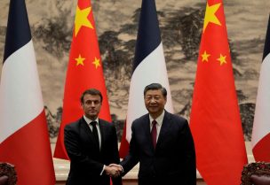French President Emmanuel Macron poses for a photo with Chinese President Xi Jinping after meeting the press at the Great Hall of the People in Beijing, China