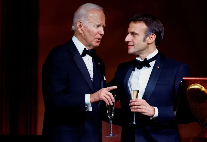 U.S. President Joe Biden speaks to France's President Emmanuel Macron while they make a toast, as the Bidens host the Macrons for a State Dinner at the White House, in Washington, U.S., December 1, 2022. REUTERS