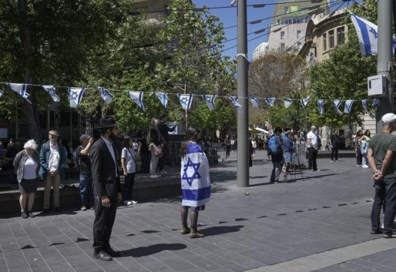 Israelis stand still to observe two minutes of silence as air raid sirens sound to mark Israel's annual Memorial Day for fallen soldiers, in Jerusalem, Tuesday, April 25, 2023. (AP)
