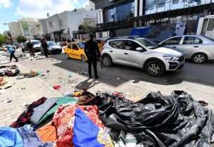 Tents and belongings of migrants are scattered in front of the UNHCR headquarters in Tunis after Tunisian police dismantled a camp for refugees from sub-Saharan African countries, on April 11, 2023. (AFP)