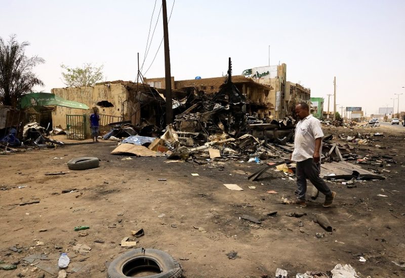 A man walks past shells on the ground near damaged buildings at the central market during clashes between the paramilitary Rapid Support Forces and the army in Khartoum North, Sudan April 27, 2023. REUTERS/ Mohamed Nureldin Abdallah