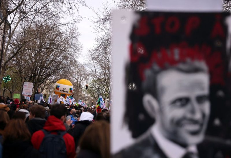 Protesters hold a drawing depicting a portrait of French President Emmanuel Macron during a demonstration as part of the tenth day of nationwide strikes and protests against French government's pension reform in Paris, France, March 28, 2023 - REUTERS