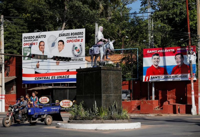 A vehicle drives past an electoral banner, a day before presidential elections, in Lambare, Paraguay April 29, 2023. REUTERS