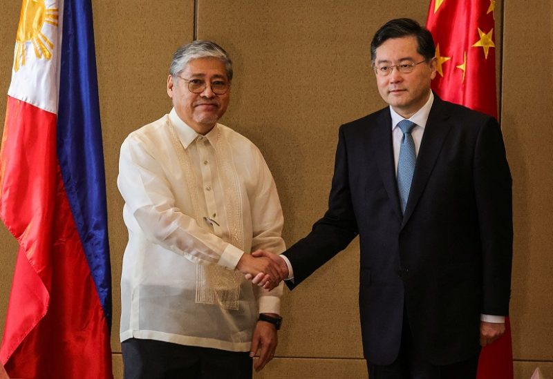 Chinese State Councilor and Foreign Minister Qin Gang and Philippine Foreign Affairs Secretary Enrique Manalo shake hands during the welcome ceremony prior to their bilateral meeting, in Manila, Philippines, April 22, 2023. Gerard Carreon/Pool via REUTERS