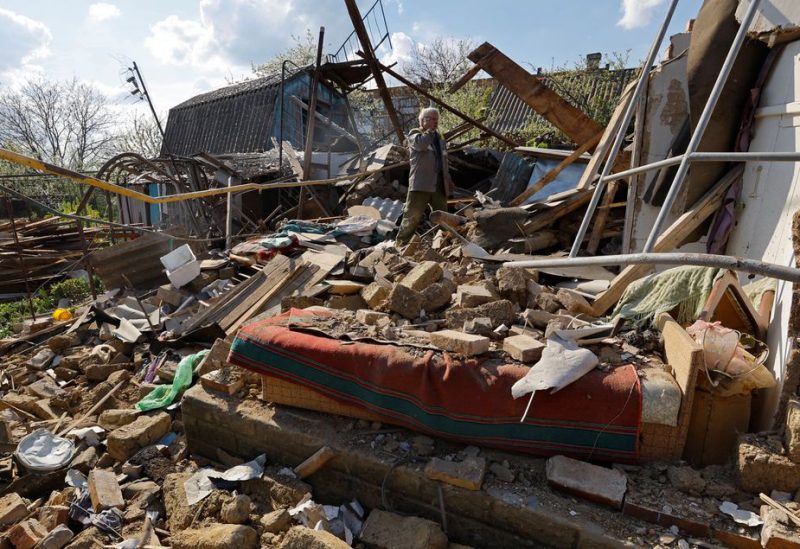 Local resident Nikolai Danko, 63, clears the rubble at the site of his house destroyed in the Donetsk region, Russian-controlled Ukraine, April 27, 2023 - REUTERS