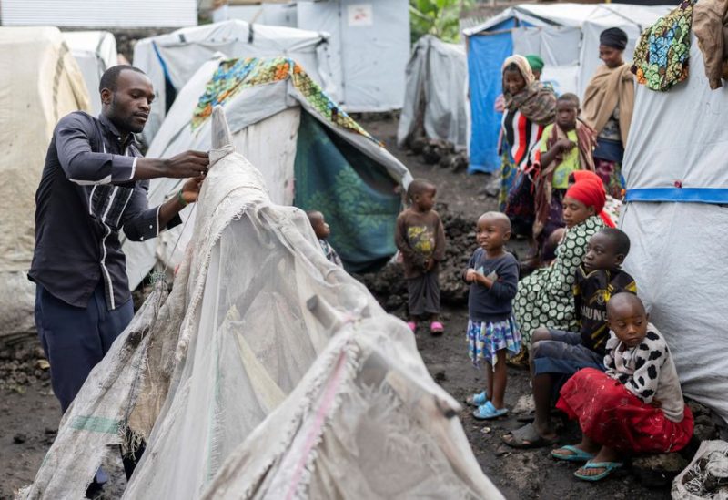 Thomas Tumusifu Buregeya, 22, repairs his mother's tent at the Congo Basin camp for the internally displaced people, in Nyiragongo territory, Goma, Congo April 6, 2023 - REUTERS