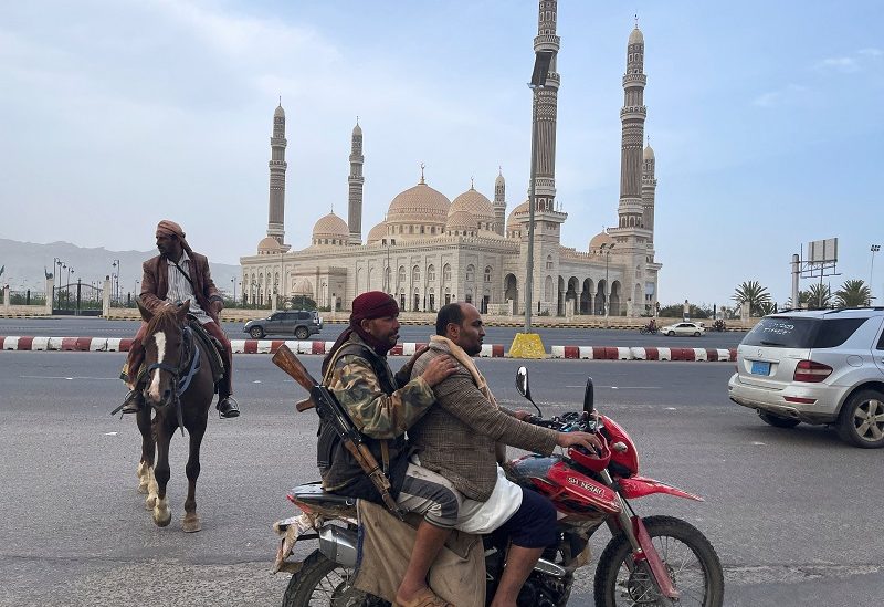 People ride on a motorbike, as Saudi and Omani delegations hold talks with Houthis, in Sanaa, Yemen April 9, 2023. REUTERS/Khaled Abdullah