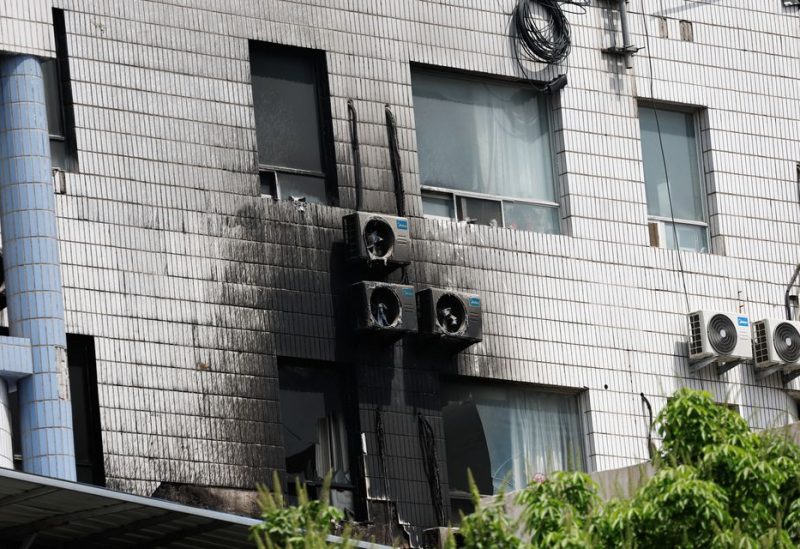Damaged windows and external air-conditioning fans are seen following a fire that occurred at the Changfeng Hospital, in Beijing, China April 19, 2023. REUTERS