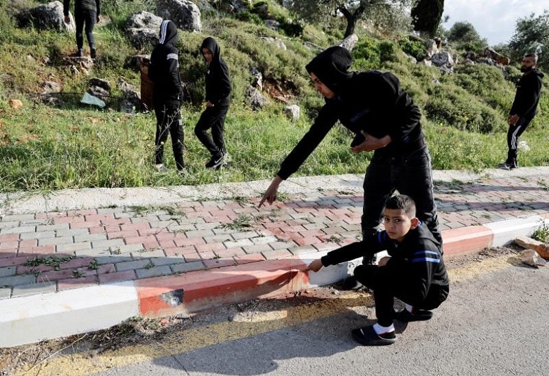 Palestinians show a bullet hole at a security incident scene near Nablus in the Israeli-occupied West Bank April 11, 2023. REUTERS/Raneen Sawafta