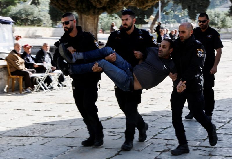 Members of Israeli security force detain a Palestinian man at the Al-Aqsa compound, also known to Jews as the Temple Mount, while tension arises during clashes with Palestinians in Jerusalem's Old City, April 5, 2023. REUTERS/Ammar Awad