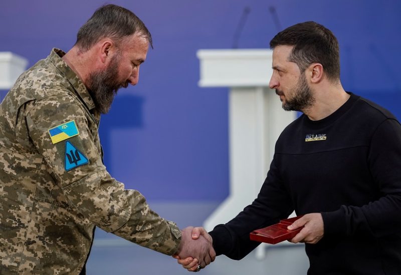 Ukrainian President Volodymyr Zelenskiy honors Muslim soldier Ilimdar Khodzhametov with The "Defender of the Motherland" medal, before sharing iftar with Ukrainian Muslim soldiers, the meal to end Muslim fast at sunset, during the holy fasting month of Ramadan, in a front of a mosque in the outskirts of Kyiv, Ukraine, April 7, 2023. REUTERS/Alina Yarysh